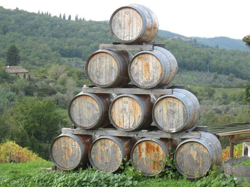 Barrels stacked in a pyramid outdoors at a winery